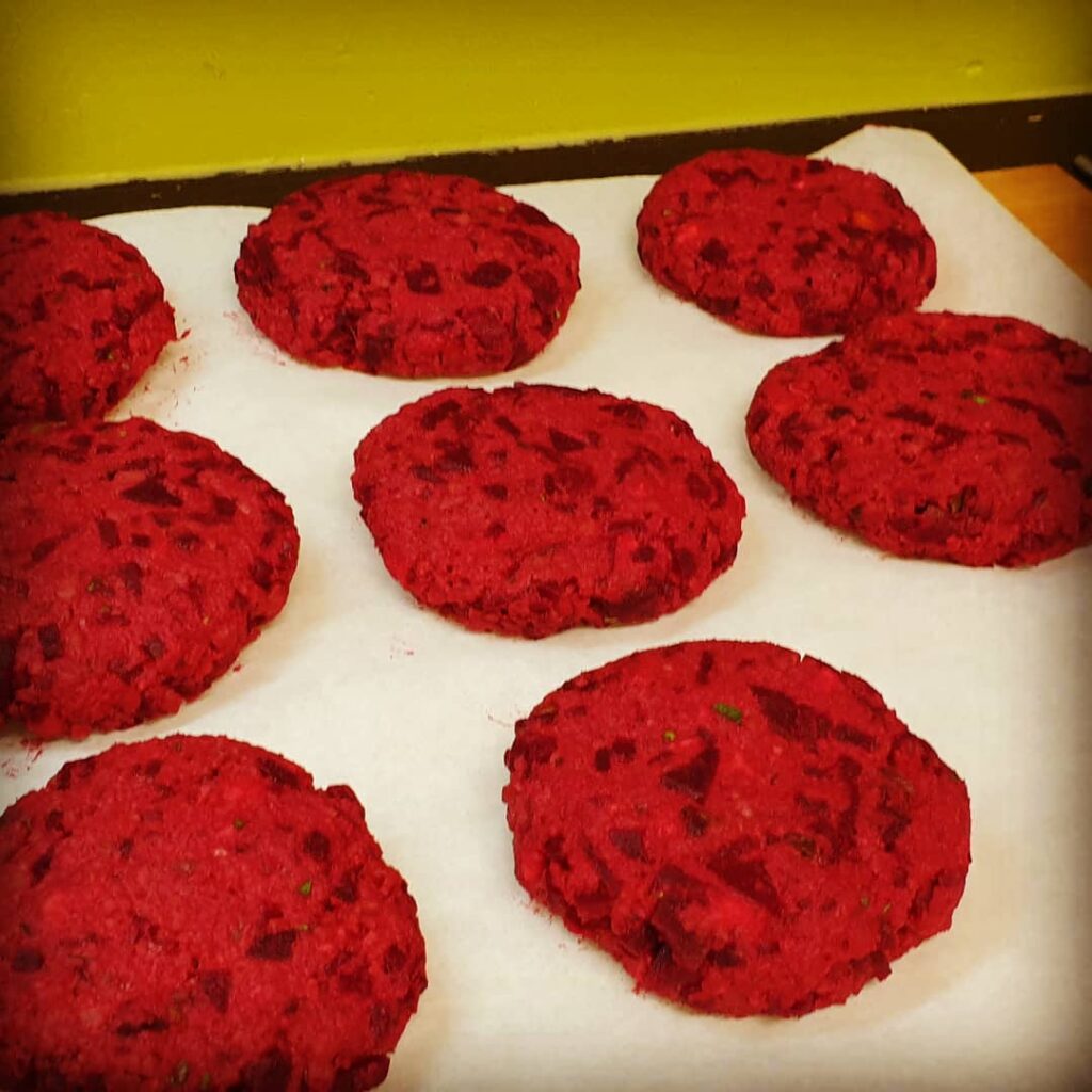 8 rote Beete Patties liegen in Reih und Glied auf einem Backpapier